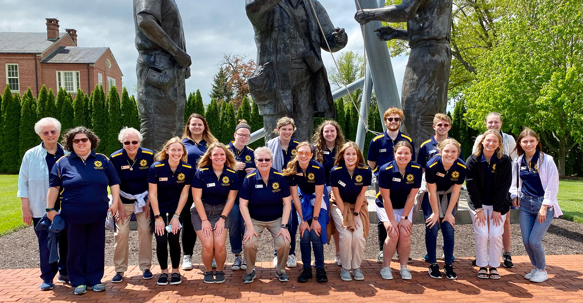MSJ mission ambassadors on pilgrimage in front of historical statues outside.