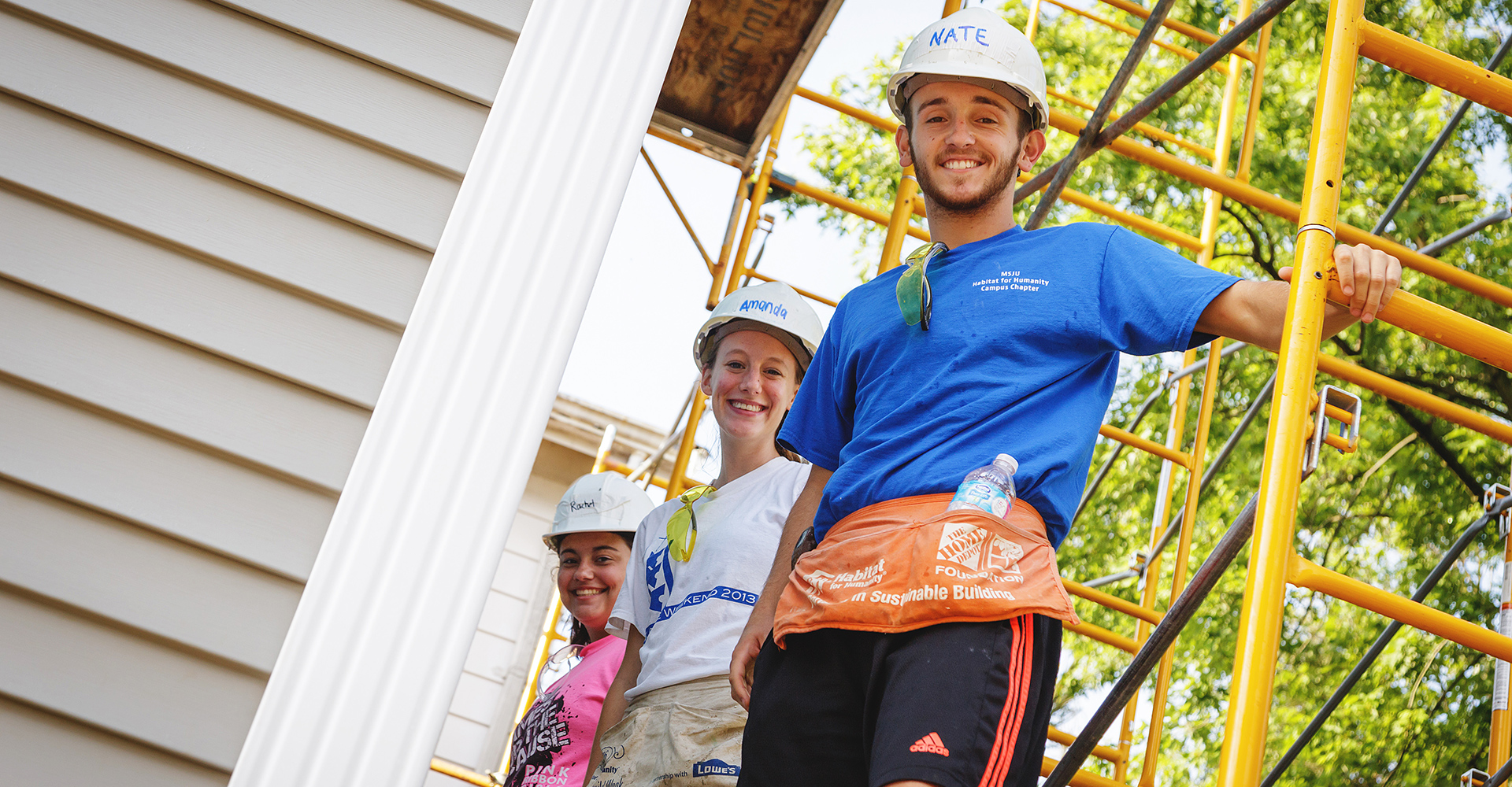 man on ladder smiling