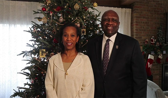 president and first lady by christmas tree smiling