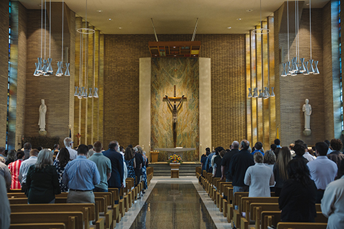church space with an altar and people in pews