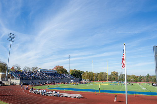 football field with turf and bleachers