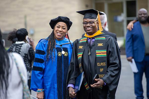 graduate next to professor