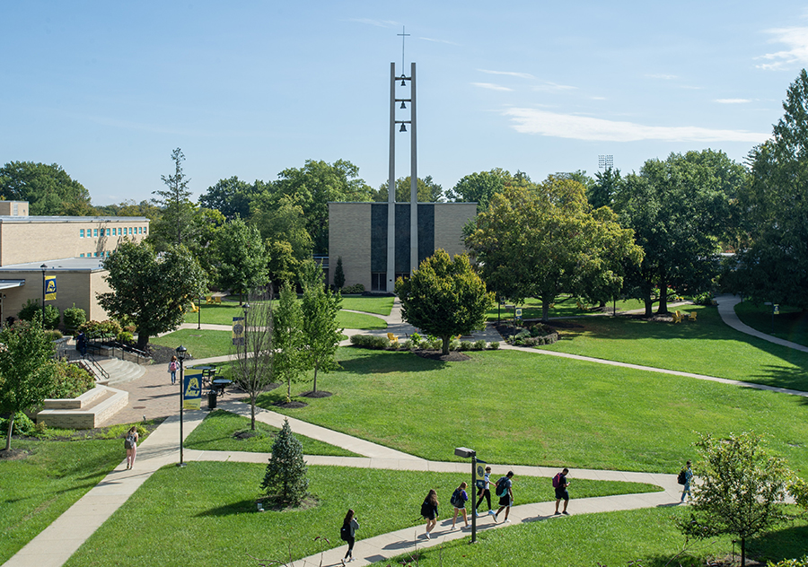 steeple and students walking in quad.