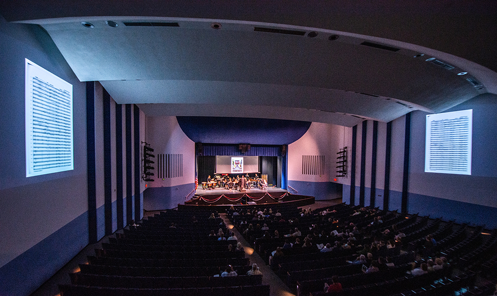 students performing on university theatre stage.