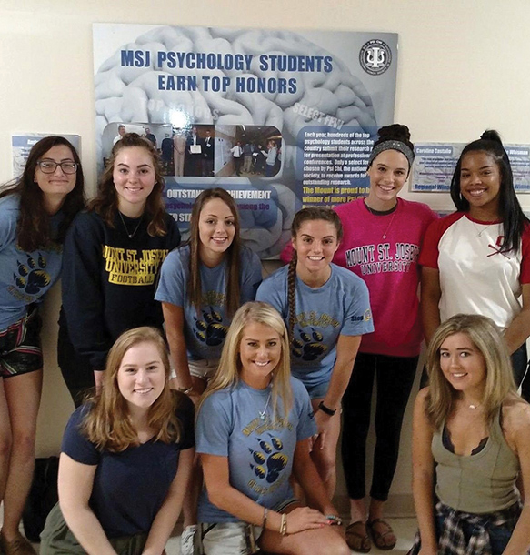 MSJ female psychology students smiling in group at conference.
