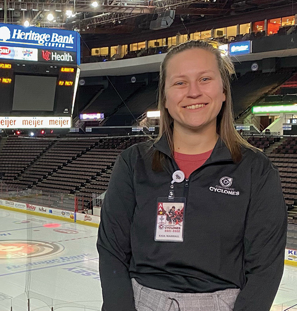 MSJ female student at us bank arena with ice rink and megatron in background