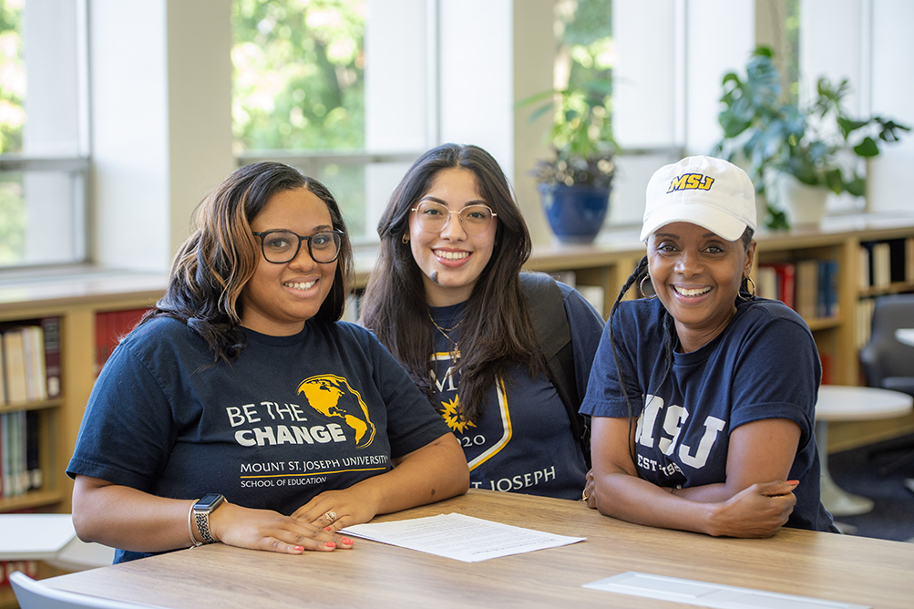 transfer students smiling in library