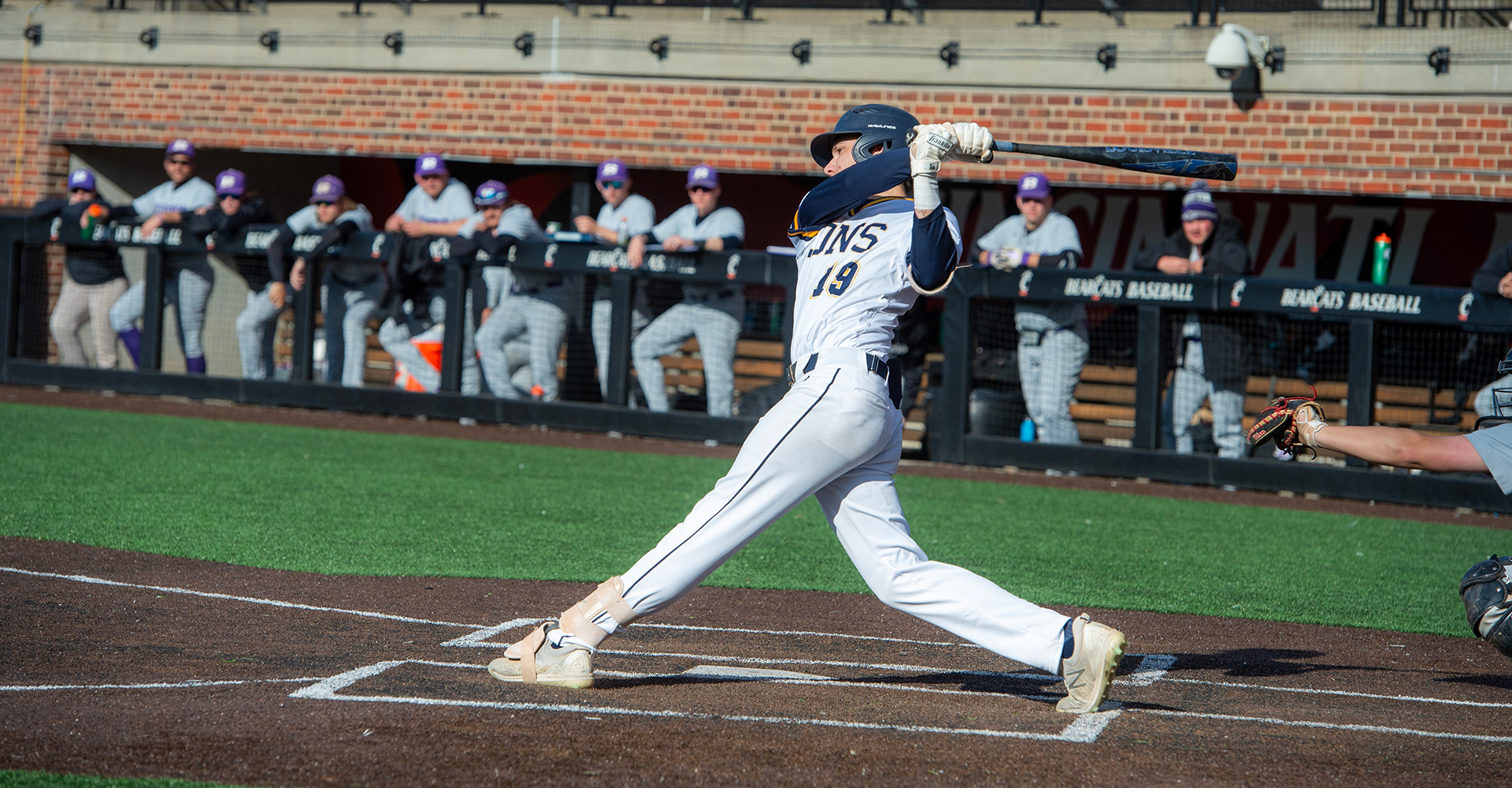 baseball player hitting ball with bat