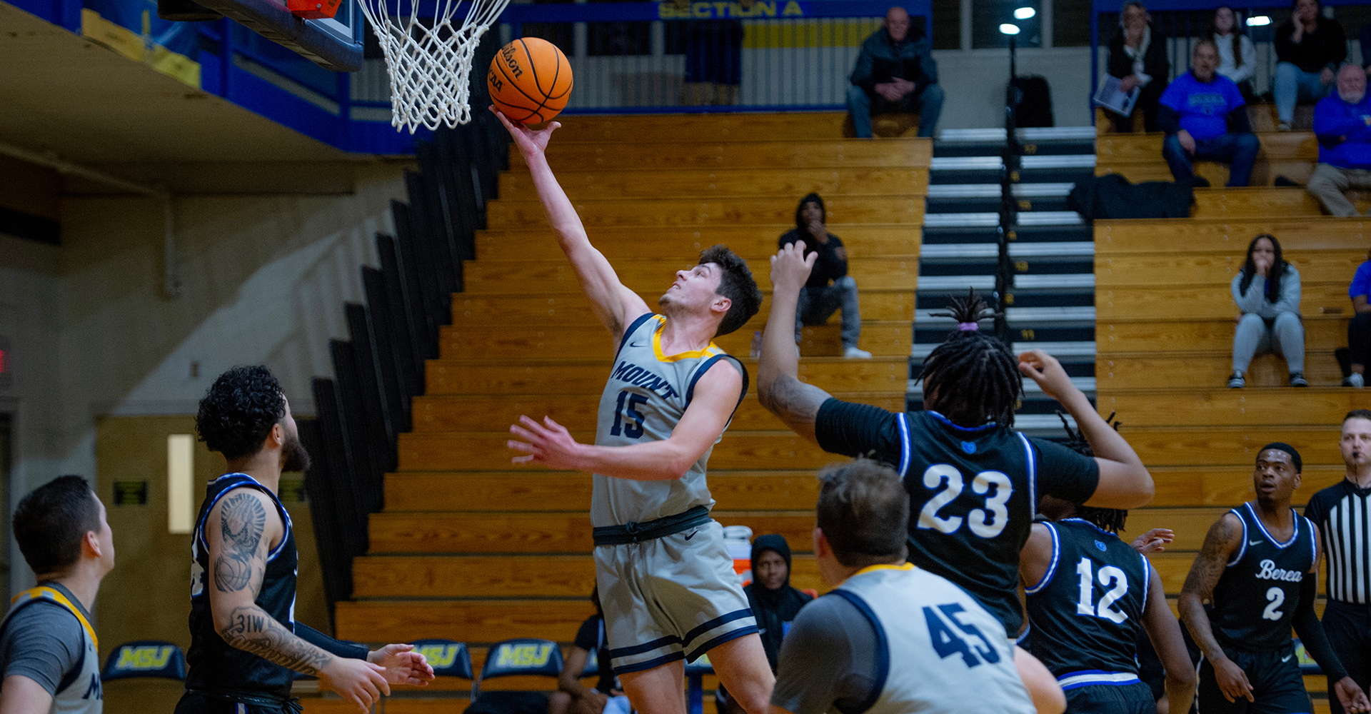 male basketball player on court shooting hoop