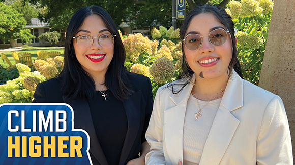 MSJ students paola and valeria smiling next to St. Joseph Statue in Mount St. Joseph University quad.