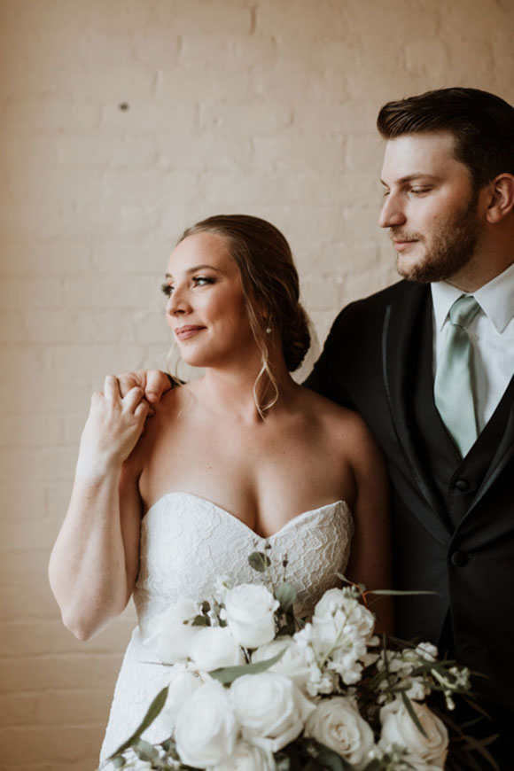 MSJ couple in wedding attire looking to the left
