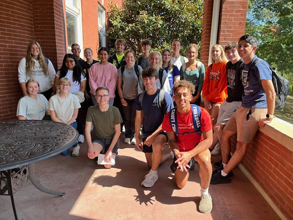 students on motherhouse porch