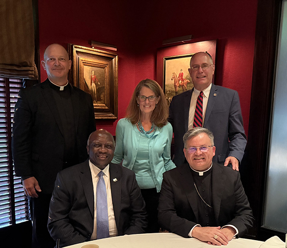 presidents at dinner table with archbishop casey smiling