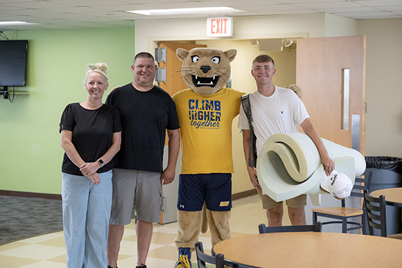 family with student and joe lion smiling