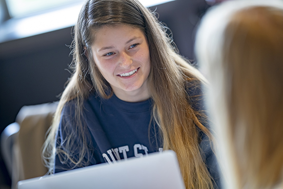 female student using laptop for financial aid.